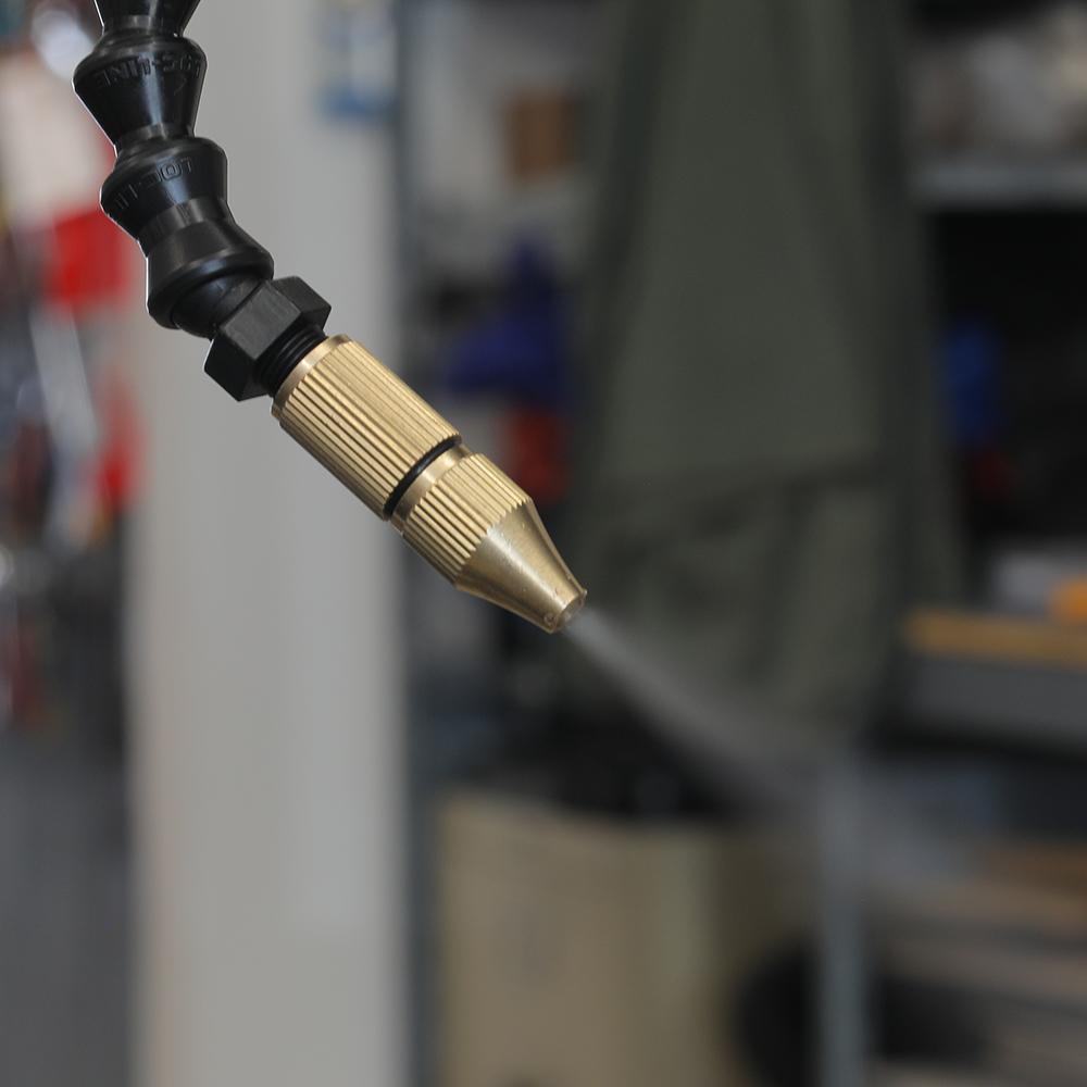 Mist coolant unit mounted beside a custom NS CNC machine, with a coolant reservoir, a needle valve for coolant flow, and a separate air regulator feeding the nozzle line