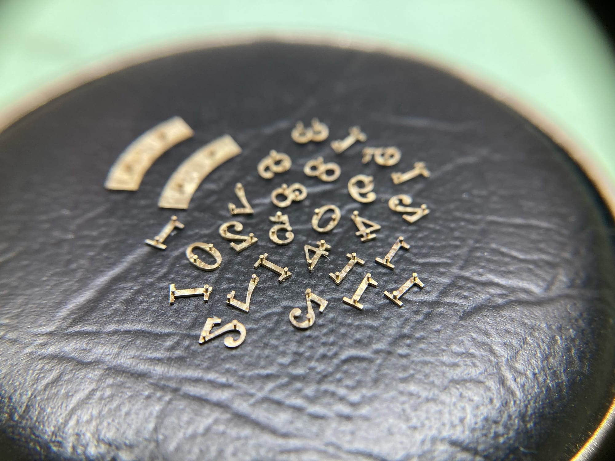 Chamfered and mirror-polished gold numerals