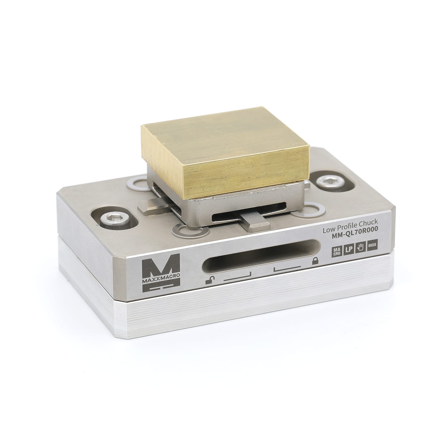 Brass workpiece on its removable pallet, seated on the machine-mounted low-profile chuck base with lock and unlock markings